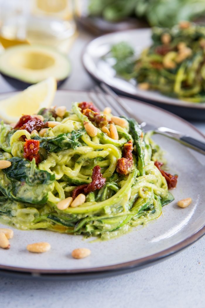 Avocado Pesto Zoodles with Spinach and Sun-Dried Tomatoes from The Roasted Root